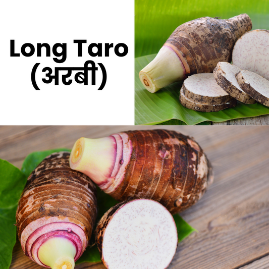 Long Taro with slices on a green leaf and wooden surface, labeled in English and Hindi.
